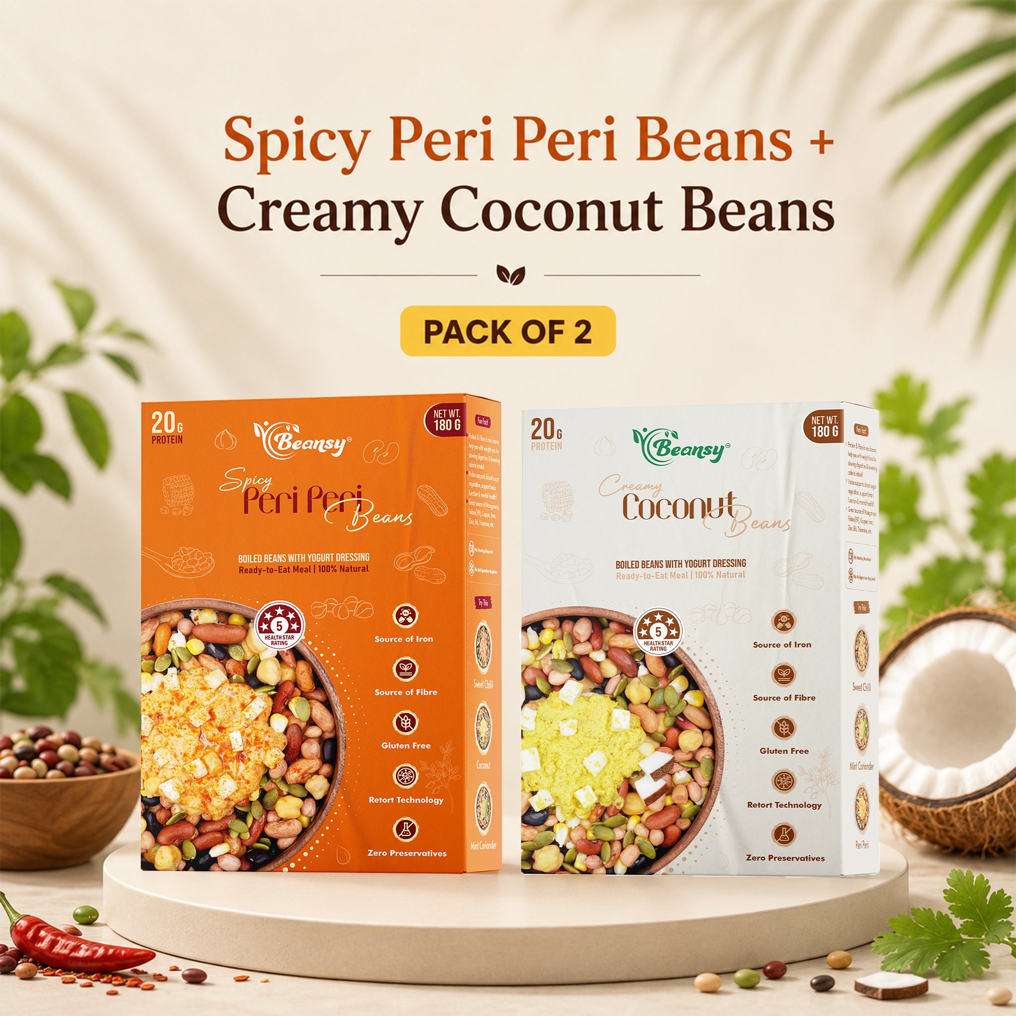 Two boxes of spicy peri peri beans and creamy coconut beans on a decorative stand with a natural background.