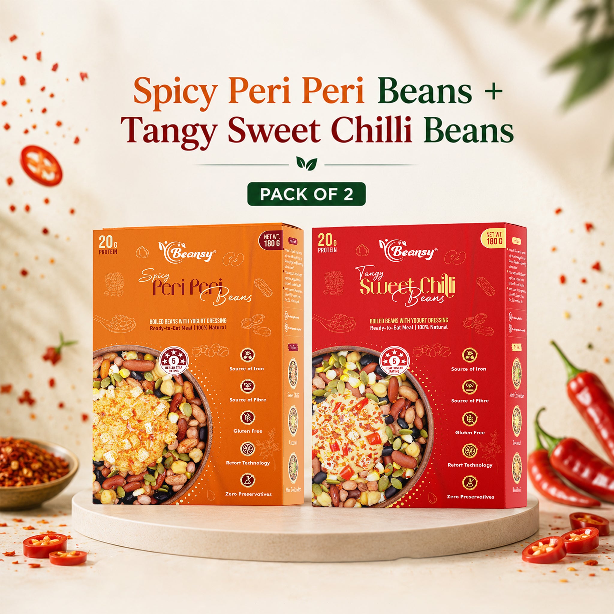 Two boxes of 'Spicy Peri Peri Beans' and 'Tangy Sweet Chilli Beans' on a decorative background with chili peppers and spices.